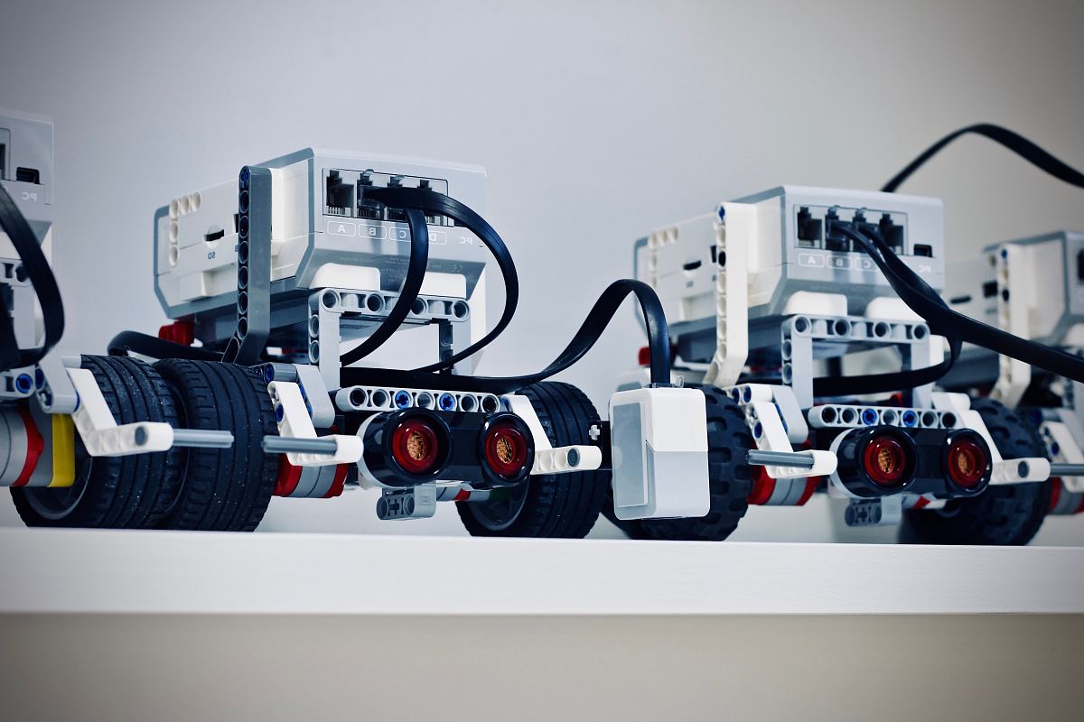 two white and black electronic device with wheels